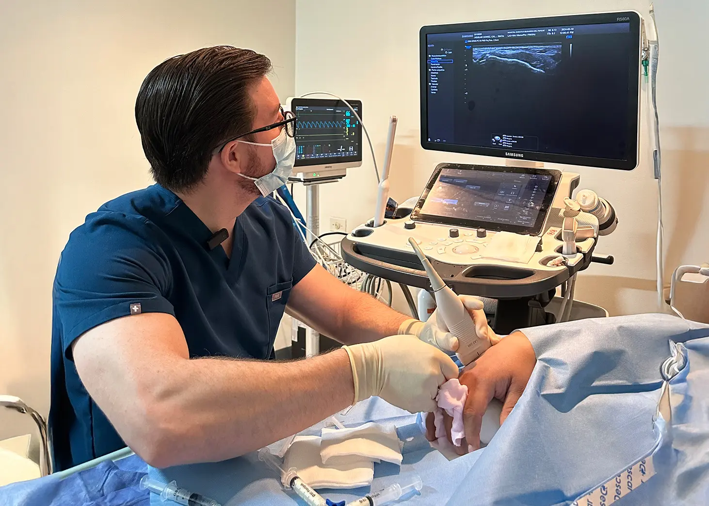 Doctor visualizing a sonogram on a patient